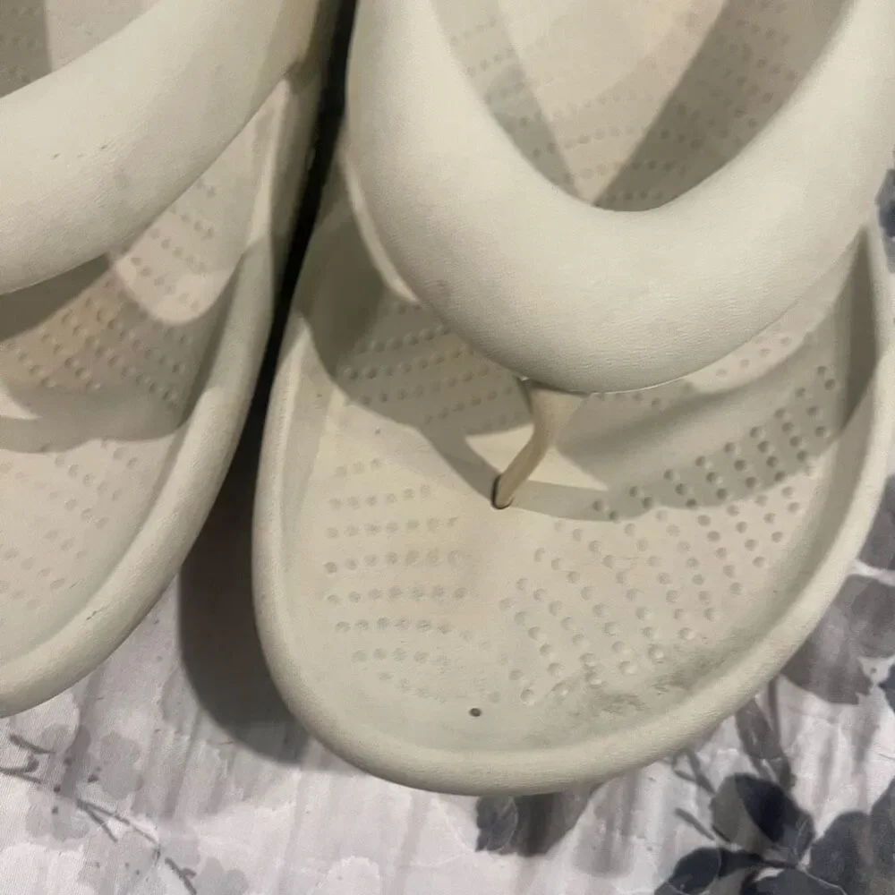 Crocs Mellow Flip sandals feature a thick, comfortable footbed designed for reco